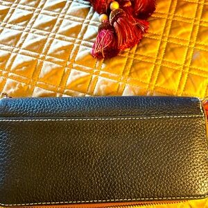 Dooney & Bourke Wallet. 2 Zippered sections. One section can fit a cell phone.